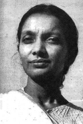 Archival photograph of Kalpana Datta in later life, in a light sari with her hair drawn back, looking directly at the camera.
